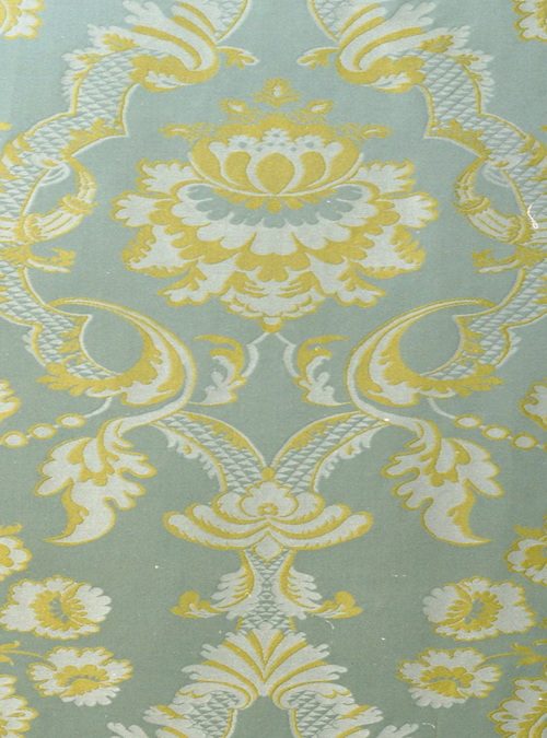 A pale blue background with a intricate yellow and white pattern
