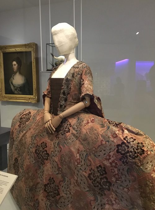 A mannequin wearing an elaborate dress at an exhibition at the V&A