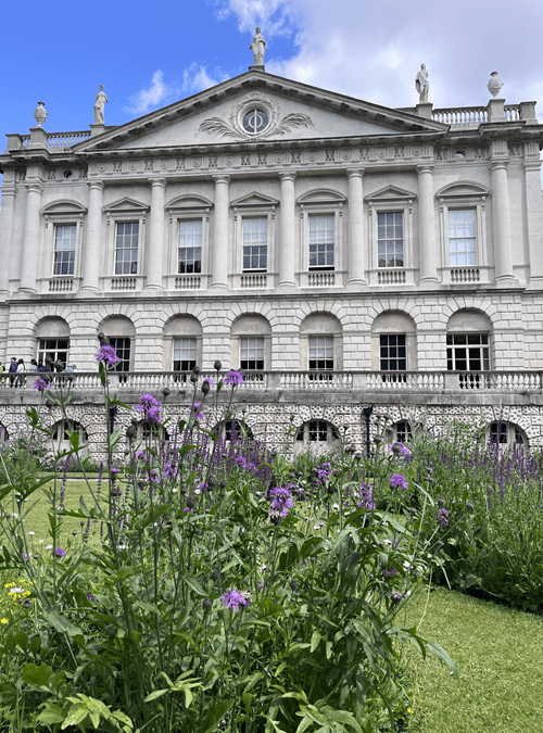 The outside of Spencer House with purple flowers in the forefront