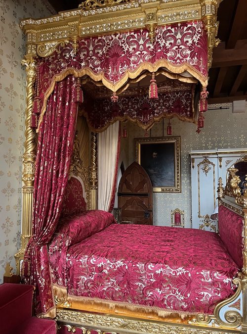 Guilded bed with half tester, bed curtains & coverlet in crimson and white silk