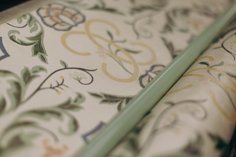 close up of cream woven fabric with floral design on loom