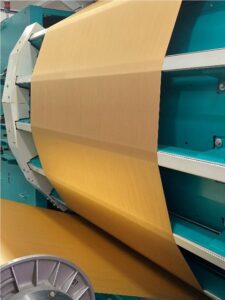 Gold warp yarn being wound for warping at Sudbury Silk Mills