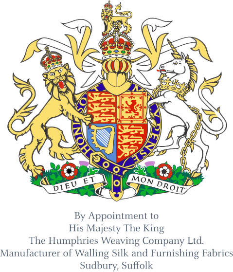 Ornate royal coat of arms featuring a crowned shield supported by a lion on the left and a chained unicorn on the right, both wearing crowns. The shield is divided into sections with heraldic symbols in red, blue, and gold. Above is a crowned helmet with decorative flourishes. Below, a banner reads “Dieu et mon droit.” Under the emblem is text: “By Appointment to His Majesty The King, The Humphries Weaving Company Ltd., Manufacturer of Walling Silk and Furnishing Fabrics, Sudbury, Suffolk.